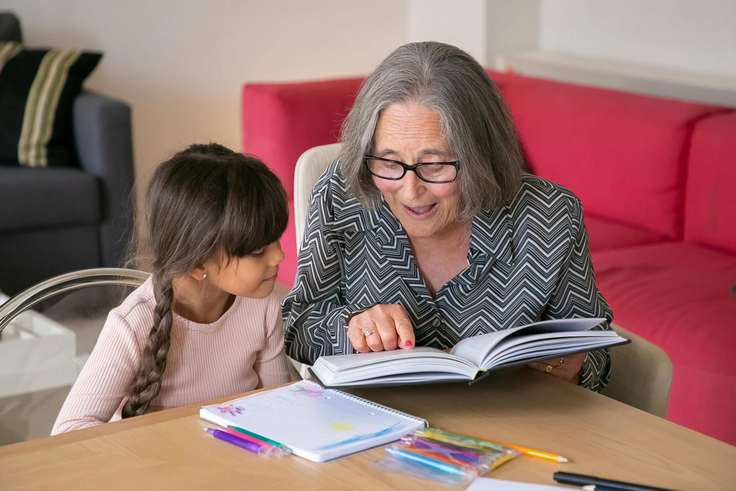 Grandma with granddaughter reading a book